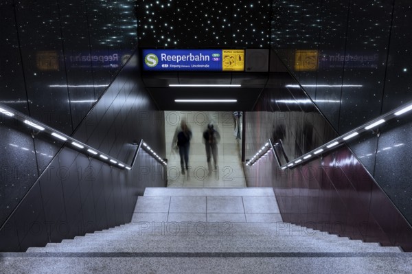Entrance to the Reeperbahn underground station while two people walk down the stairs, St. Pauli,