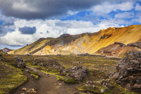 Travel to Iceland in July, volcanic summer tundra. Multi-colored rhyolite mountains - orange,