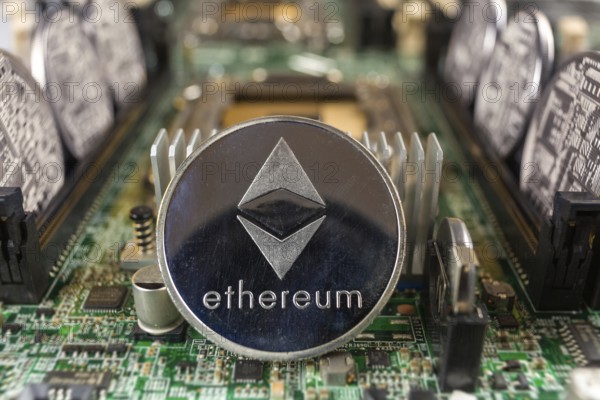 Ethereum coin close-up on a computer circuit motherboard as a blockchain technology payment network