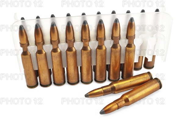 Packing ammunition for the automatic weapons and two cartridges lie separately isolated on a white
