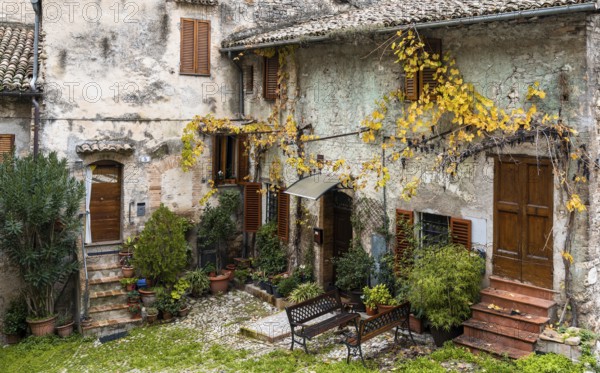 Spoleto, Italy, 25 November, 2022: rustic stone house and small backyard in the historic city