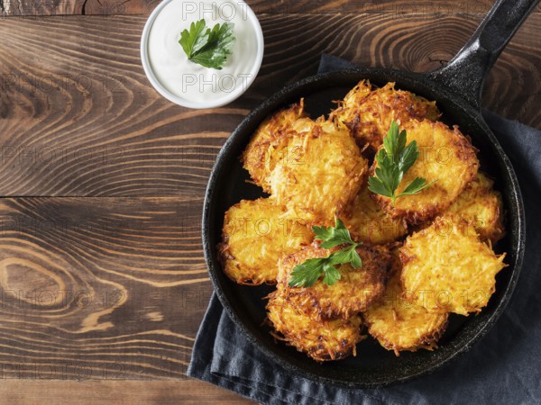 Potatoes pancakes latkes, flapjacks, hash brown or potato vada with white greek yoghurt or sour