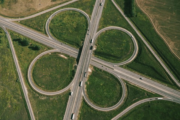 Clover or daisy type of road junction. Aerial top down view of beautiful highway road junction in