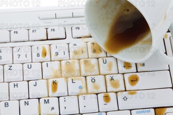 Cup of coffee spilled on a computer keyboard. Damage for insurance, Cup of coffee spilled on a
