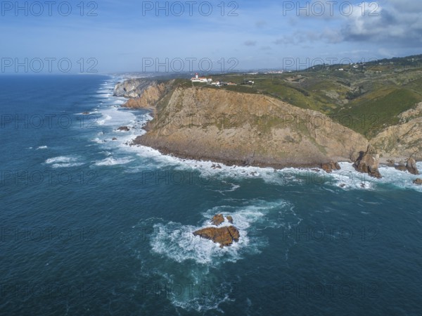 Aerial view of lighthouse at Cape Roca (Cabo da Roca) at sunset, the westernmost point of