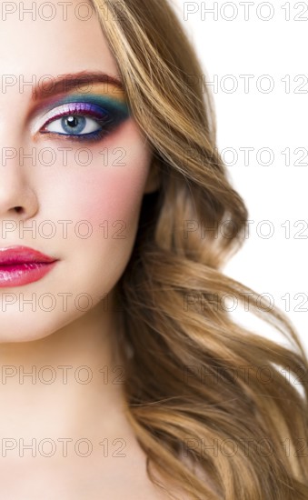 Close up portrait of a beautiful young blond model with bright make up. Close up of abstract