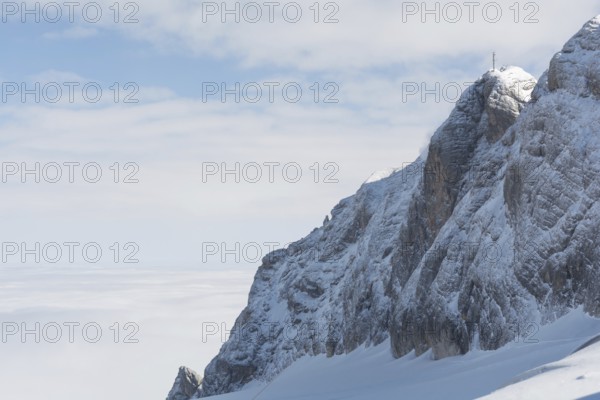 Mountain in the Dachstein region above a blanket of fog