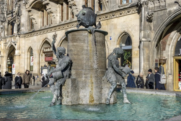 Fish fountain on Marienplatz in front of the New Town Hall in neo-Gothic style, Munich, Upper