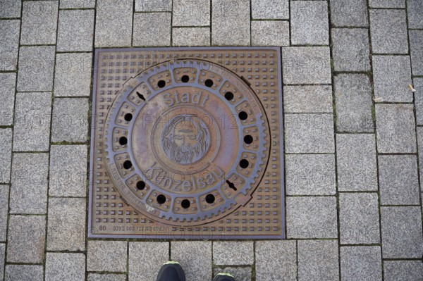 Manhole cover with motif on John the Baptist, Bible, town coat of arms, coat of arms, Künzelsau,