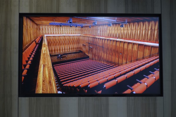 Würth Museum 2, interior view of an auditorium with wooden wall panelling and red seats, Carmen