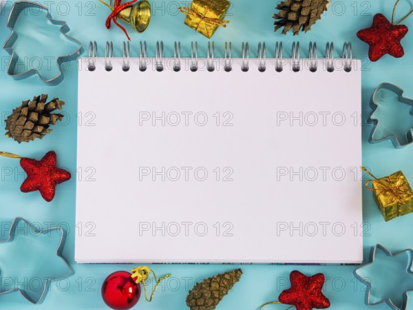 Christmas background with blank notebook, decorations. Copy space. Top view or flat lay. Toned