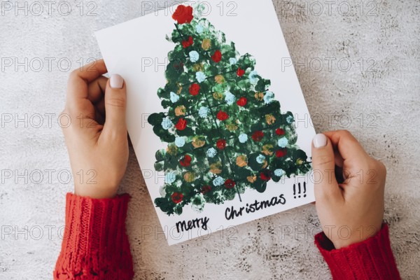 DIY Making greeting card Handmade crafts on holiday for children. Paint with fingers Merry