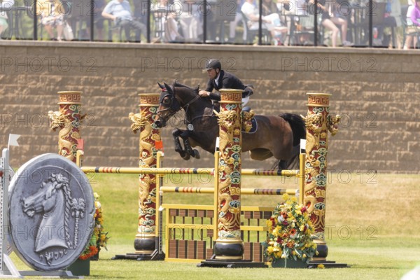 Kyle King of the United States and riding Odysseus, compete in the 1.60m Grand Prix during The
