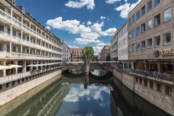 Germany, 07 26 2018: Historical buildings reflecting at the banks of the river Pegnitz, Europe