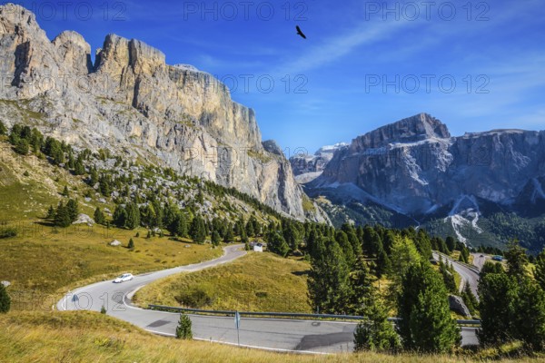 Picturesque road through the Sella Pass, Dolomites. The concept of extreme and ecological tourism.