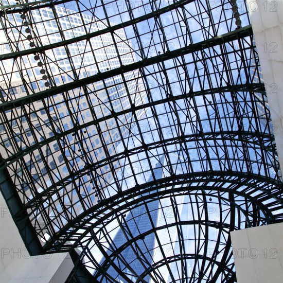 View of skyscrapers through the glass ceiling of the World Financial Centre in New York, NY, USA,