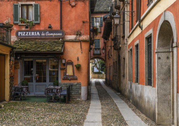Orta San Giulio, Italy, 13 March, 2023: colorful shabby buildings in the old town center of Orta