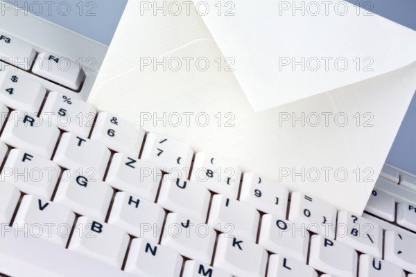 The keyboard of a computer and an envelope. Communication via e-mail, The keyboard of a computer