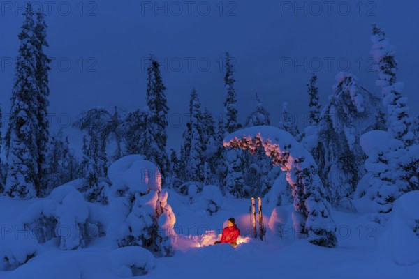 Man around a campfire, Muddus National Park, Laponia World Heritage Site, Norrbotten, Lapland,