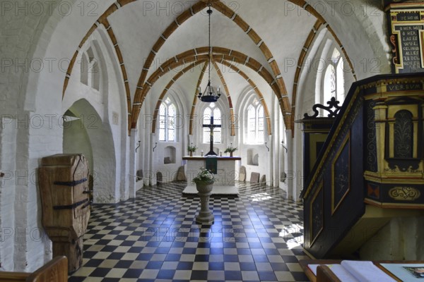 Historic church interior with pulpit and stained glass windows, suggesting silence and