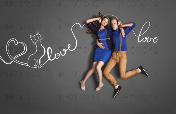 Happy valentines love story concept of a romantic couple sharing headphones and listening to music