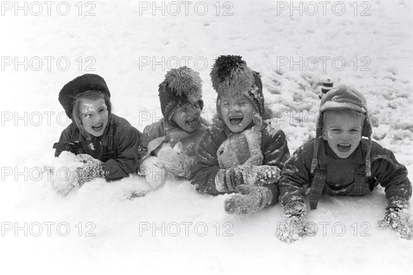 Winter in the 1950s. Children are playing in a park in Stockholm. They don't seem to be freezing.