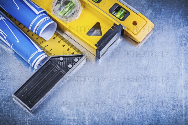 Blue engineering drawings construction levels square ruler on metallic background