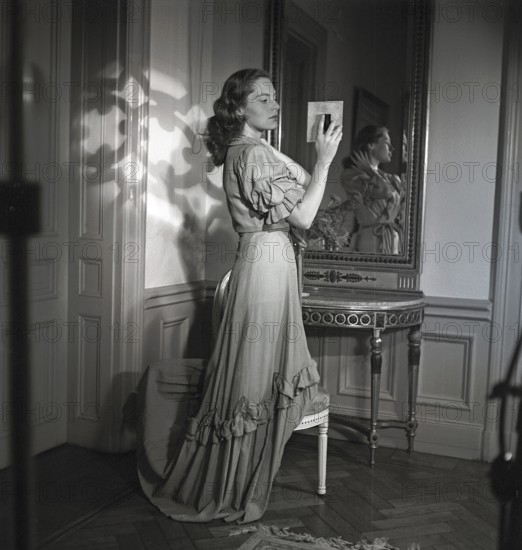 Viveca Lindfors. Swedish-American Actress. 1920-1995. She is looking at herself in two mirrors to