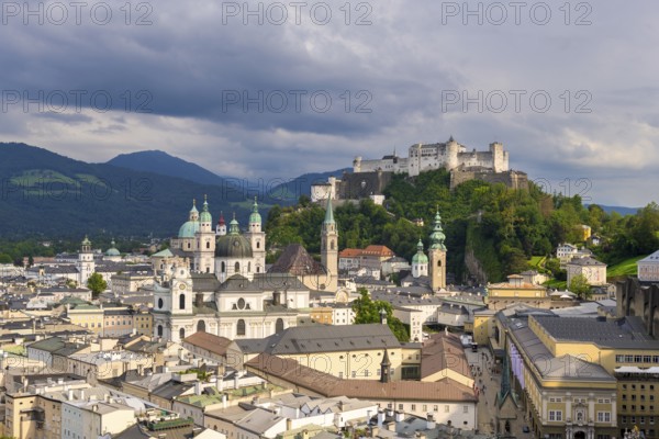 Summer view of the historic centre of Salzburg with Hohensalzburg Fortress and cloudy sky,
