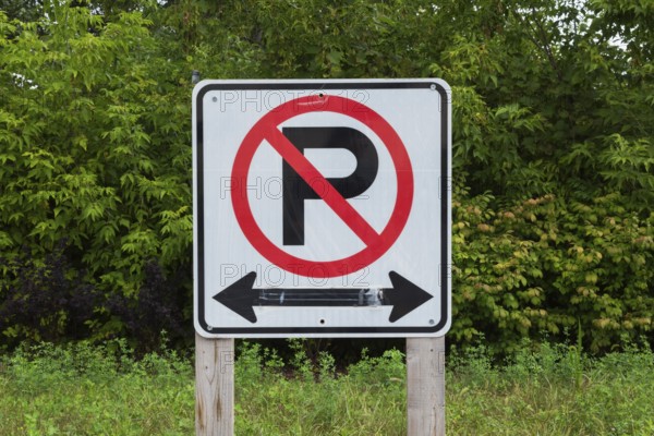 Large white, black and red No Parking with Left and Right direction arrows pictogram notice sign