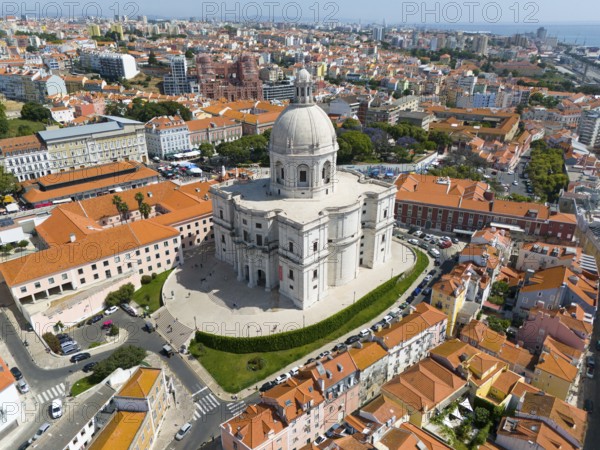 City view from above with central dominated dome-shaped structure surrounded by dense buildings,