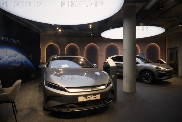 View through shop window to showroom, sales exhibition of the car brand BYD Build Your Dreams,