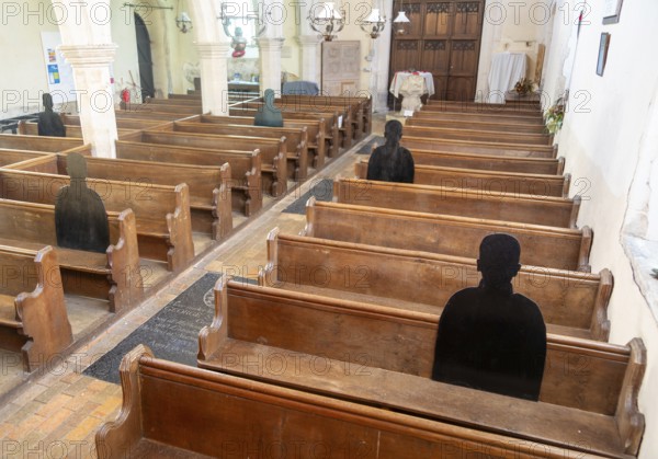 First World War remembrance figures of soldiers sitting in church pews, Framsden, Suffolk, England,
