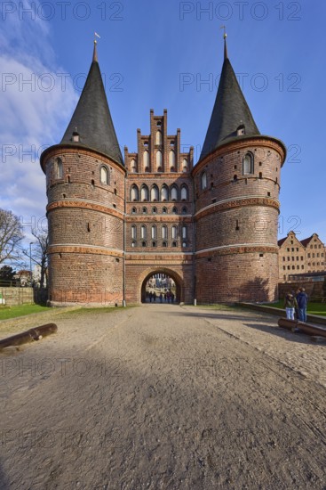 City gate, historic brick building, footpath made of sand, Holstentorplatz, Hanseatic city of