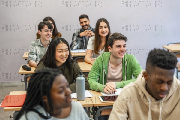 Multi ethnic university students attending a lesson and smiling, concept of education and