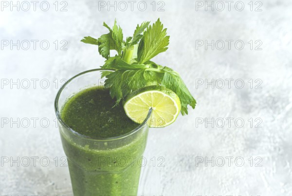 Glass with green smoothie, celery and spinach, apple and kiwi, cucumber, vegetable smoothie,