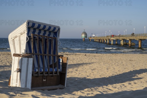 Beach chair on the sandy beach, tourists on the Vineta Bridge, pier with diving gondola, Zinnowitz,