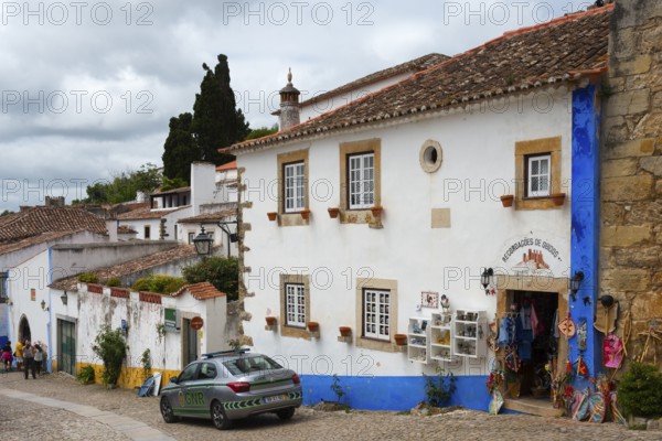 Street scene with traditional buildings and a souvenir shop in a picturesque town, R. Direita,