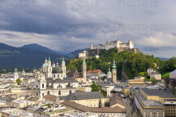 Panorama of the historic centre of Salzburg with Hohensalzburg Fortress and dramatic cloud cover,