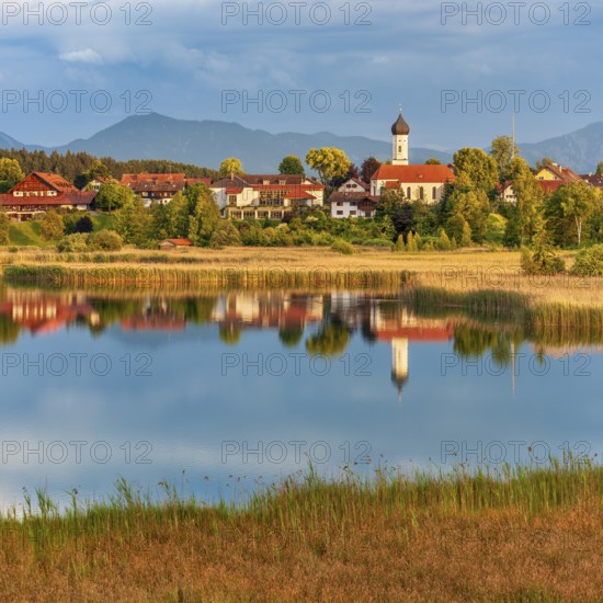 View over the Sengsee lake to Iffeldorf with St. Vitus church in autumn, Osterseen, Fünfseenland,