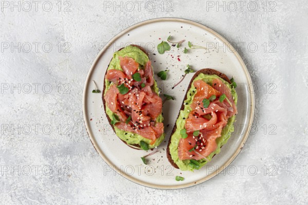 Breakfast, Sandwiches with smoked salmon and avocado, on dark rye bread, with microgreens, on a