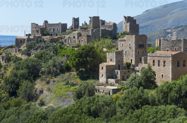 Detailed view of historic stone houses of a hilltop village, residential towers, Vathia, Ithylo,