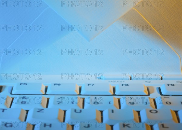 The keyboard of a computer and an envelope. Communication via e-mail, The keyboard of a computer
