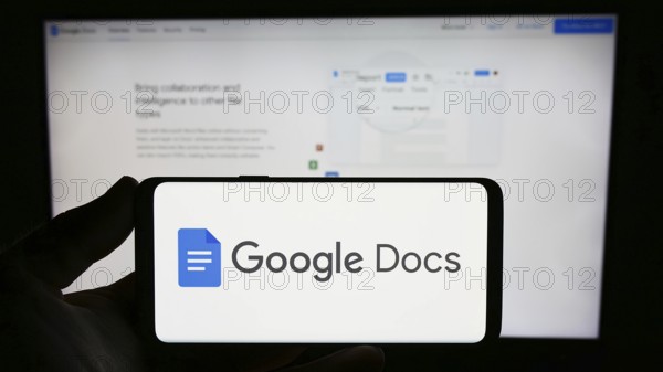 Stuttgart, Germany, 09-23-2023: Person holding smartphone with logo of online word processing
