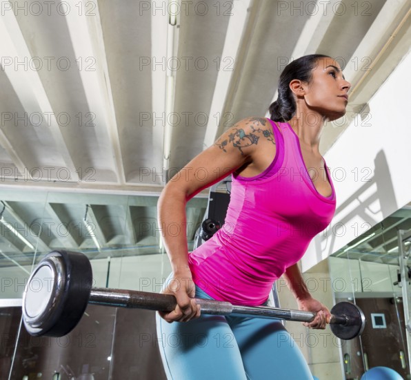 Barbell bent over row supine grip woman workout at gym exercise
