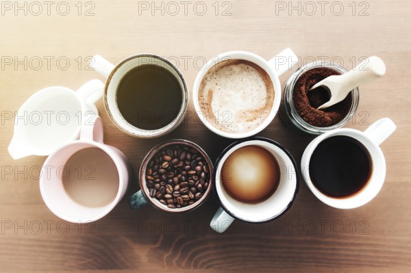 Multiple coffee cups and multicolored mugs with americano, espresso, latte and cappuccino, milk