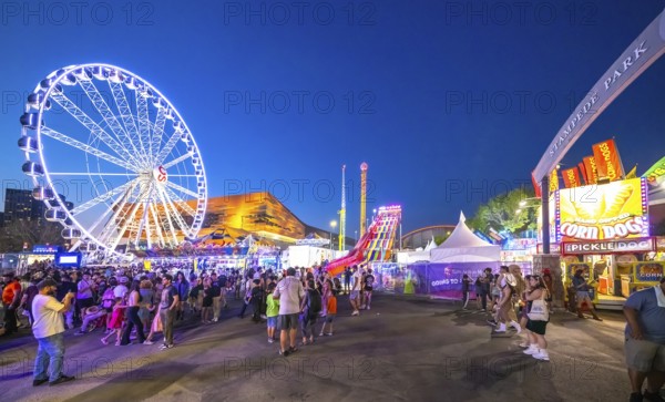Calgary, Alberta, Canada. Jul 22, 2024. A vibrant evening at Stampede Park, featuring a brightly