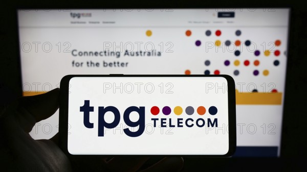 Stuttgart, Germany, 12-30-2022: Person holding cellphone with logo of Australian company TPG
