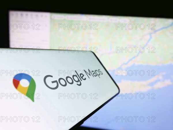 Stuttgart, Germany, 03-10-2023: Smartphone with logo of web mapping platform Google Maps on screen