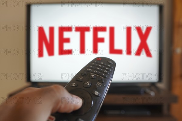 April 20, 2024, Brazil. In this photo illustration, a hand holding a TV remote control in front of